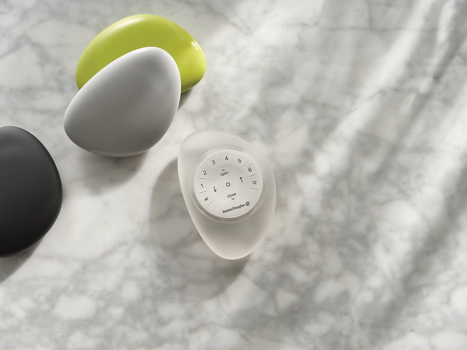 Detail image of a white remote for window treatment automation from the brand Hunter Douglas at The 