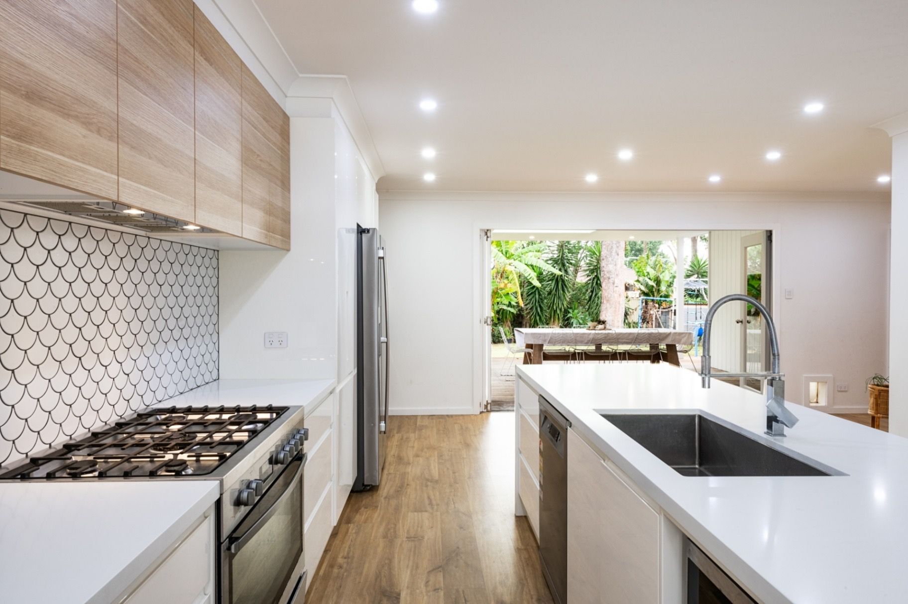 ontemporary kitchen featuring sleek cabinetry and stainless steel appliances
