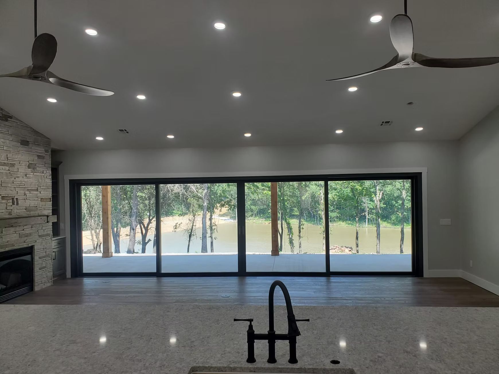 Interior view of a modern kitchen with a large sliding glass door a