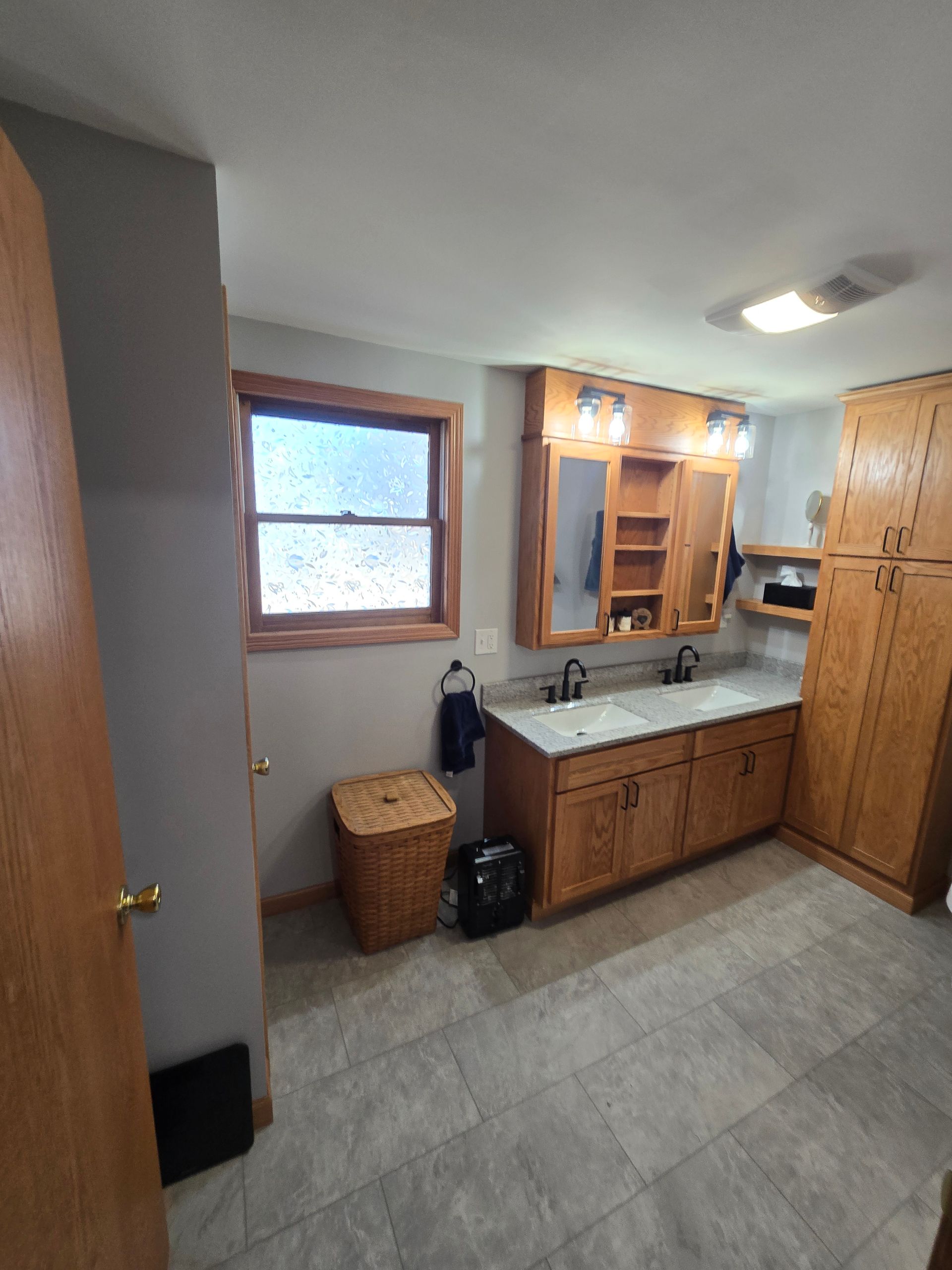 A white truck is parked in a parking lot next to a building.