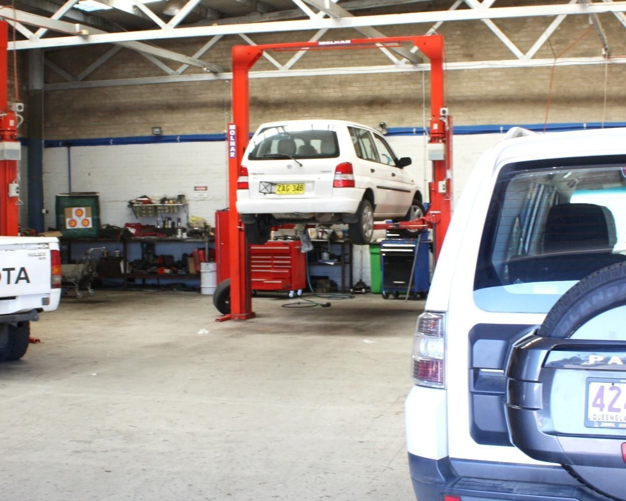 A White Toyota Truck Is Parked In A Garage — Carson's Car Care In Armidale, NSW