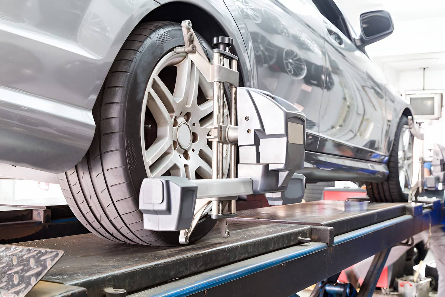 A Car Is Being Aligned With A Machine In A Garage — Carson's Car Care In Armidale, NSW