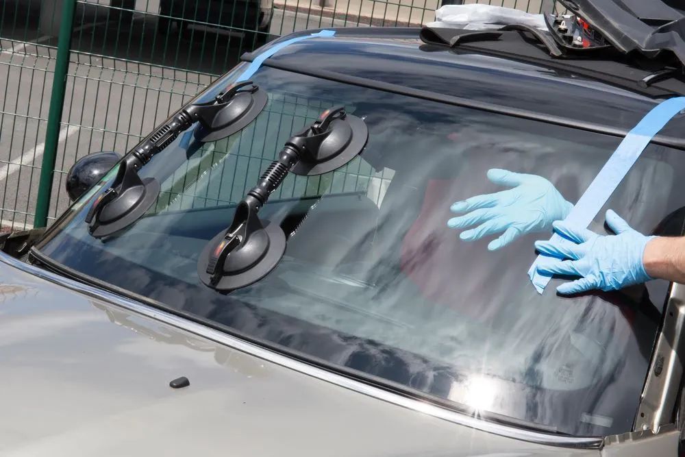 Windshield Being Repaired With Suction Cups — Southern Tablelands Windscreen Repairs in Exeter, NSW