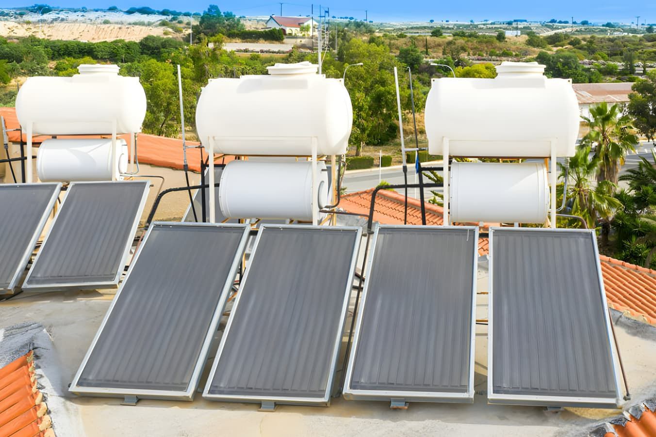 A Row of Solar Panels and Water Tanks on Top of a Roof — Tweed Pool Shop in Currumbin, QLD
