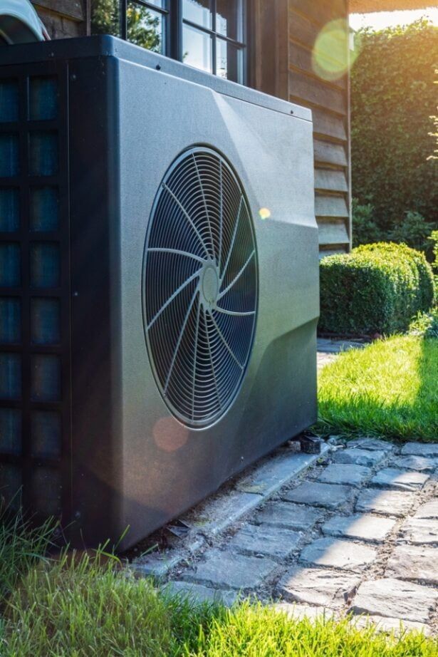 A Large Air Conditioner is Sitting on the Side of a House — Tweed Pool Shop in Tweed Heads South, NSW