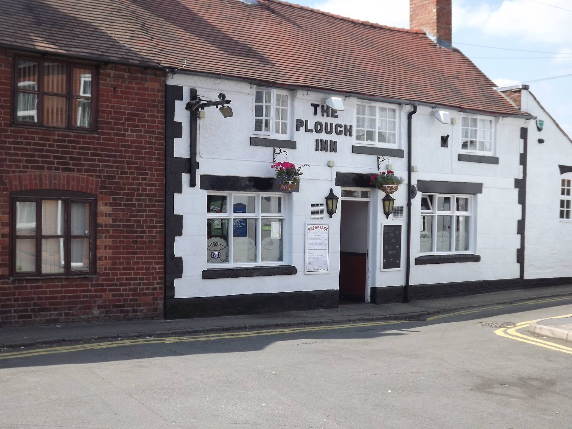 A white building with the word plough on it