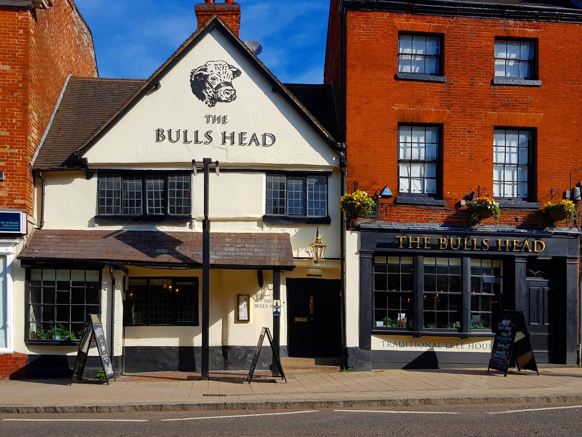 The bulls head is a brick building with a white facade