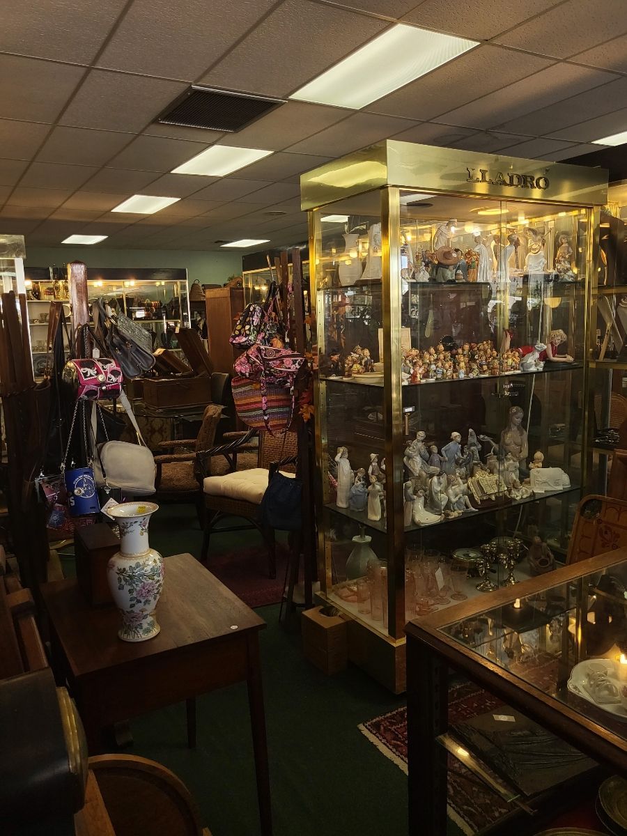 Table displaying artwork, candlesticks, and decorative items
