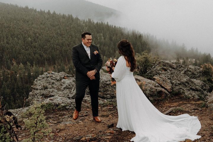 Woman with blonde and brown braided updo; indoors, seated.