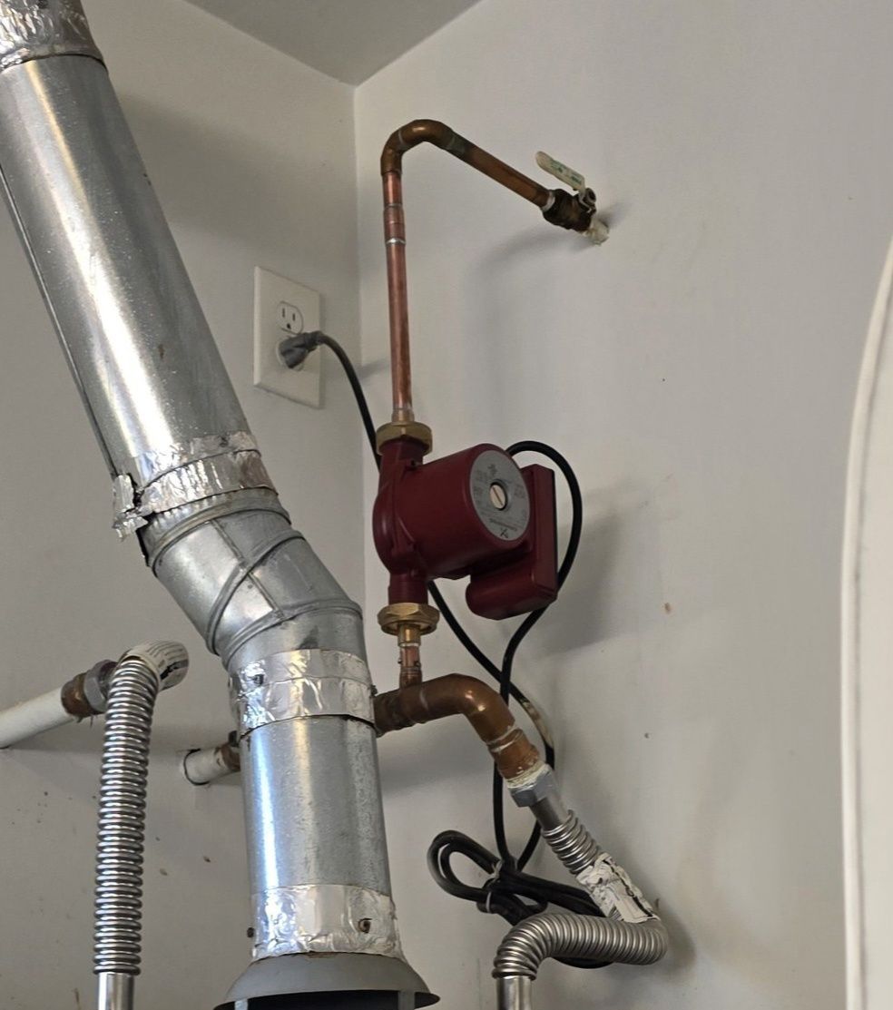 A metal pipe with a red pump attached to it