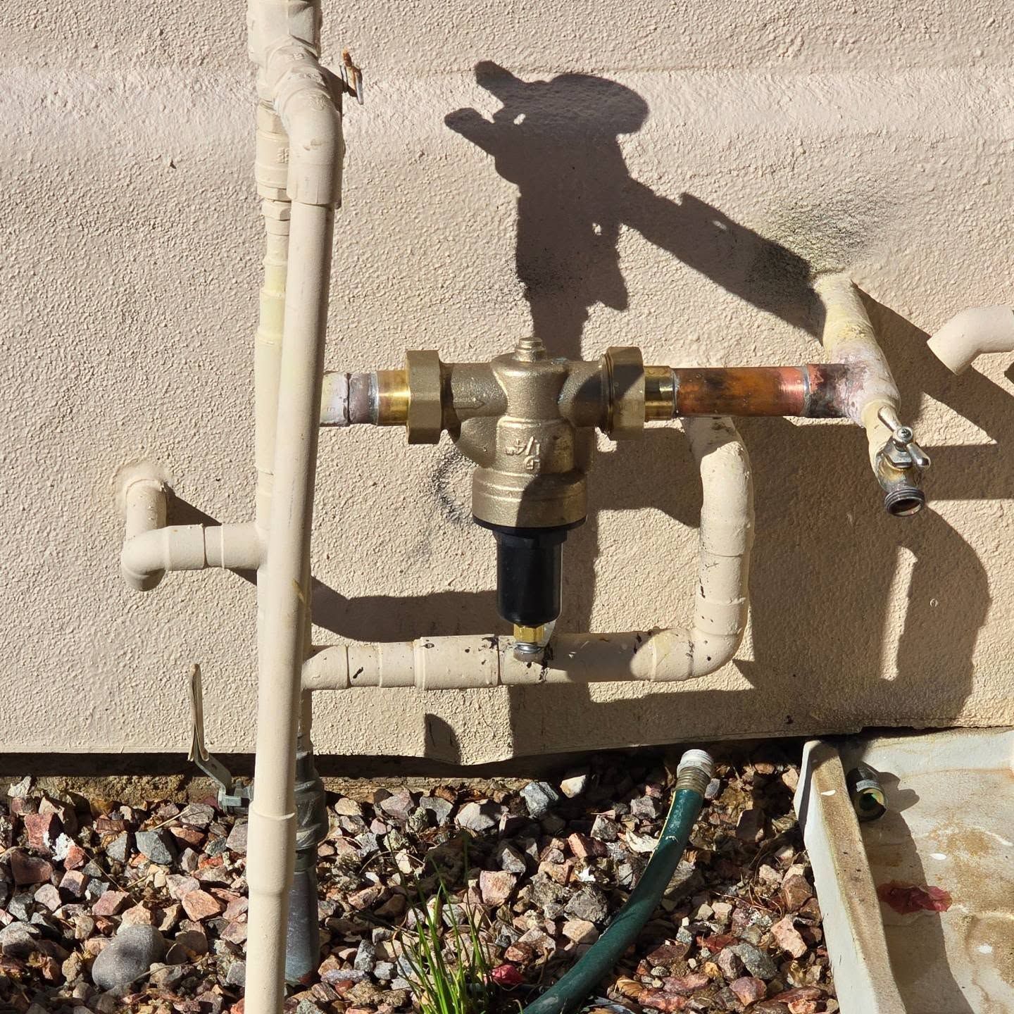 A hose is attached to a pipe with a valve on it