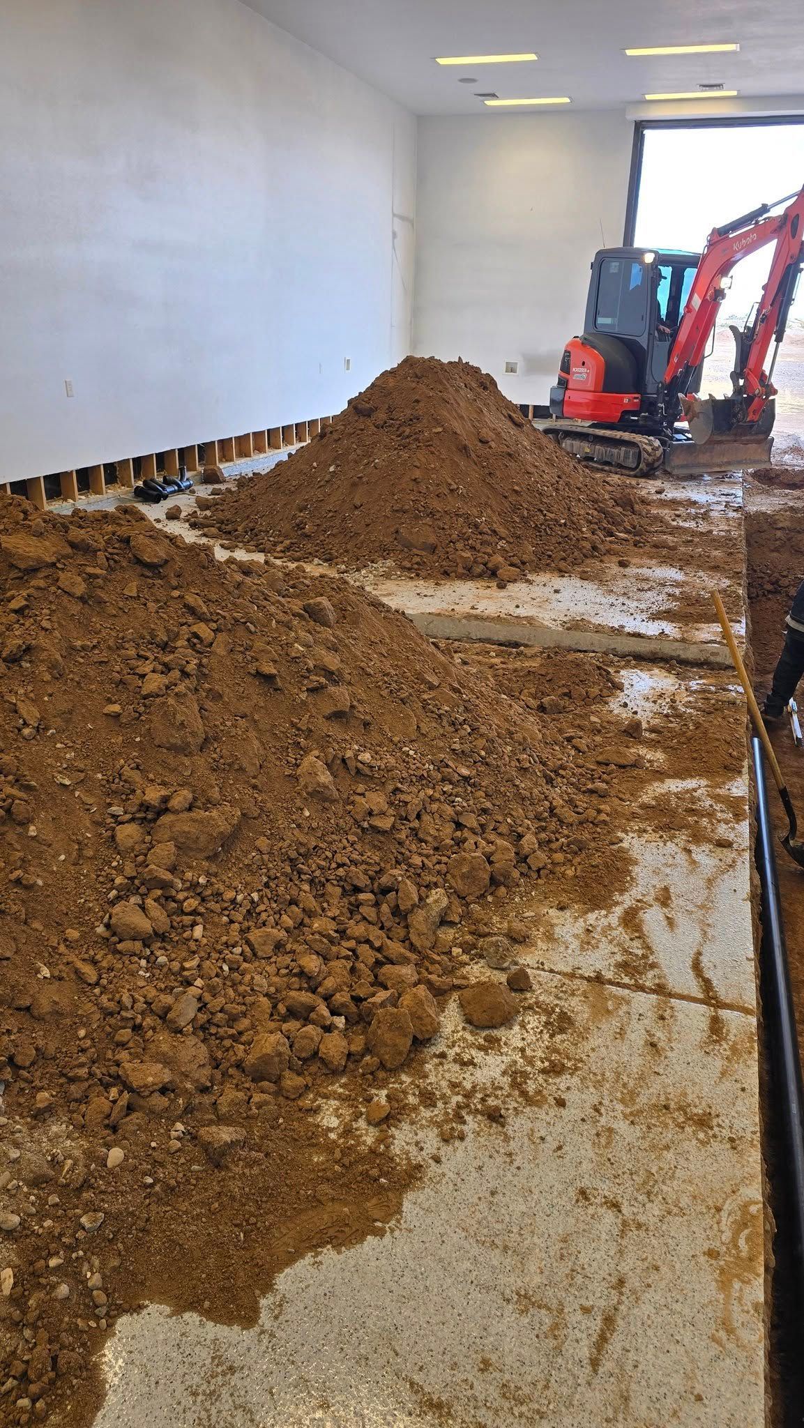 A large pile of dirt is sitting on the floor of a building.