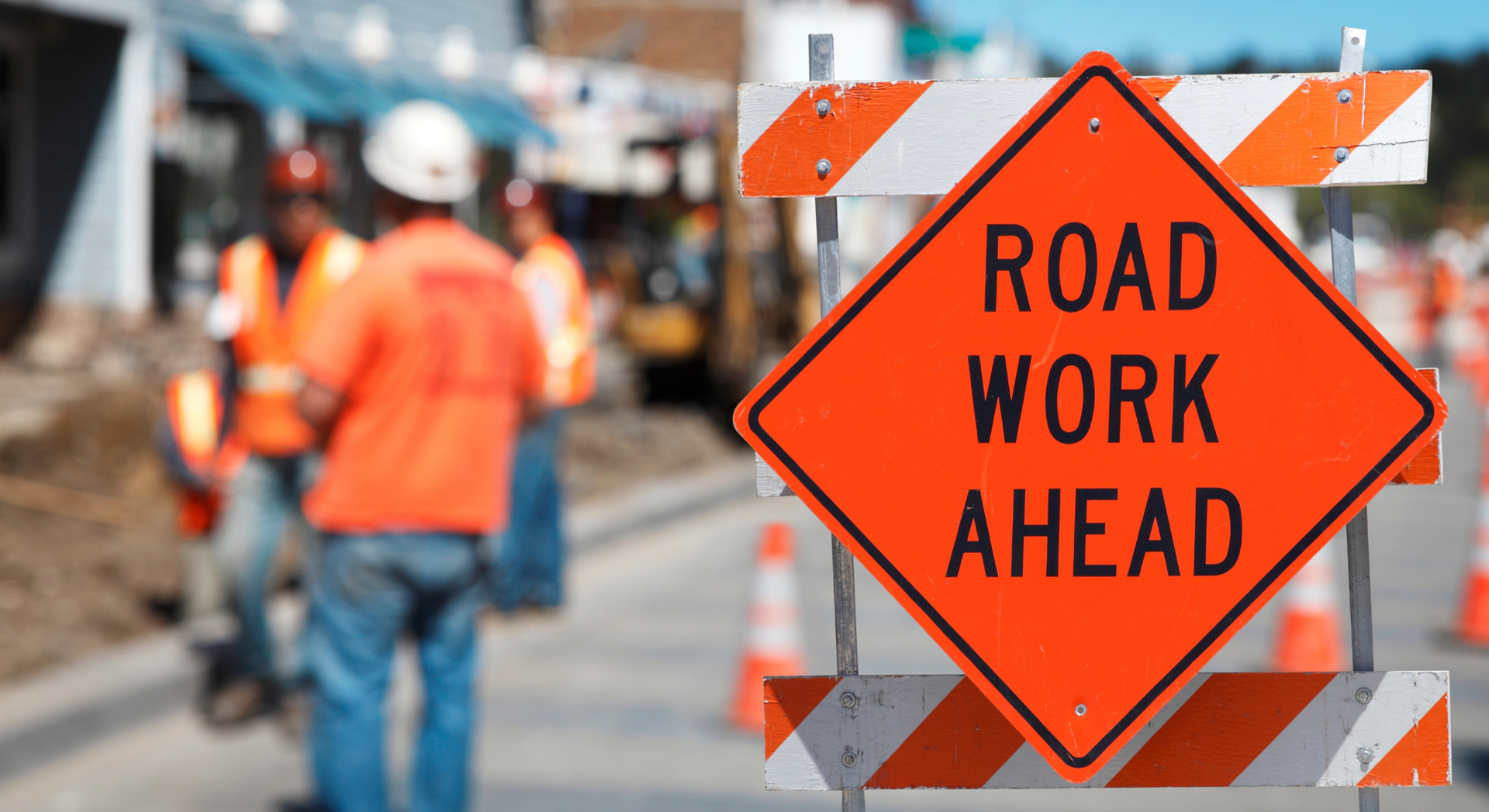 A construction site with a sign that says road work ahead