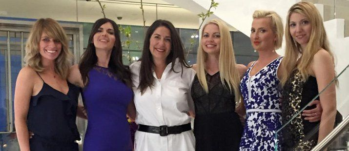 A group of women are posing for a picture together.