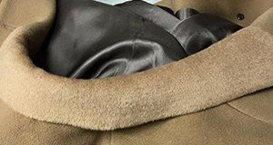 A close up of the inside of a tan coat.