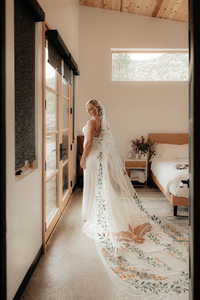 The back of a white lace wedding dress on a mannequin.