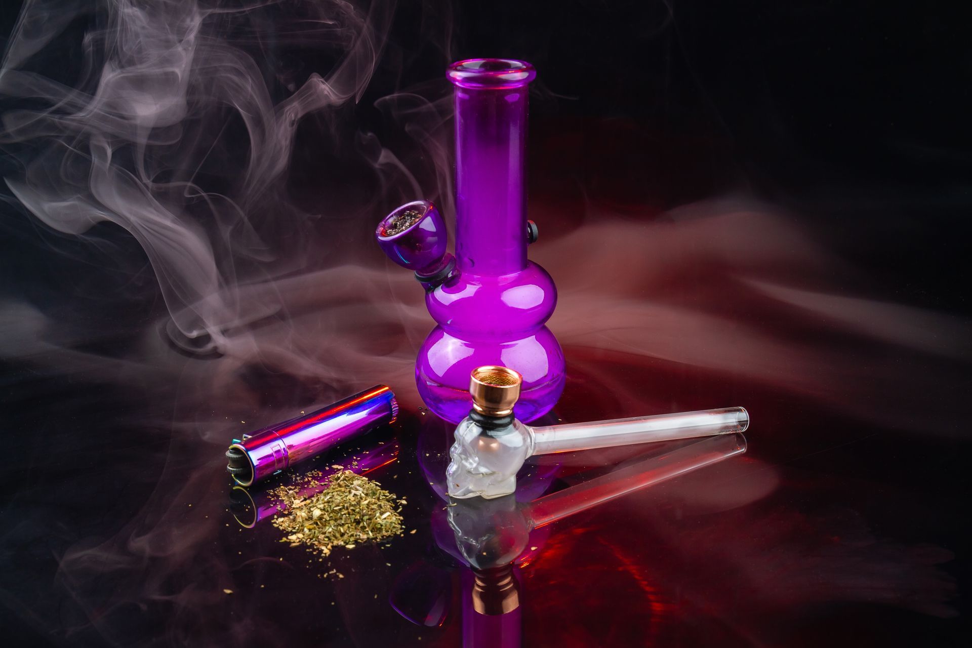 A purple bong with smoke coming out of it on a table.
