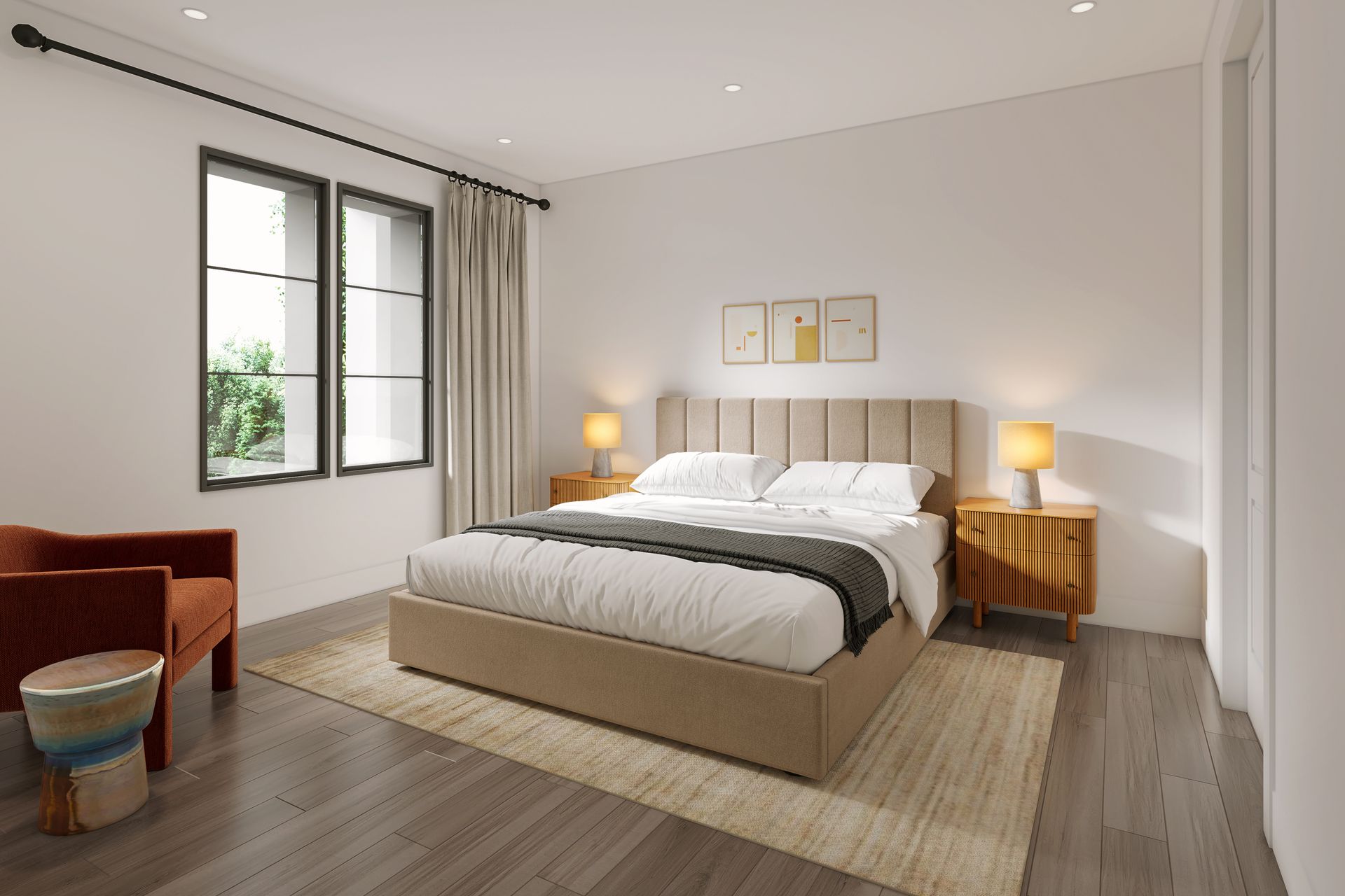 A bedroom with a bed, two nightstands, an orange chair, and a small stool. There's a window with curtains and art above the bed.