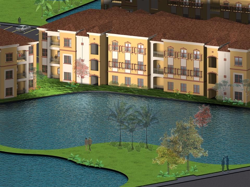 Apartment building with a tan facade and red tile roof overlooking a lake and grassy island with trees.