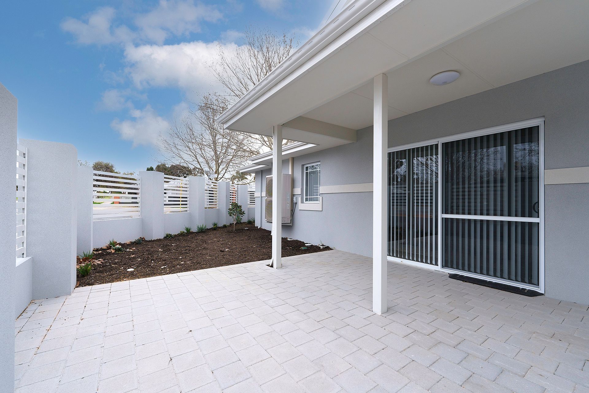 Ilios Living accommodation for people with disabilities – Carlie location with a covered porch and sliding glass doors