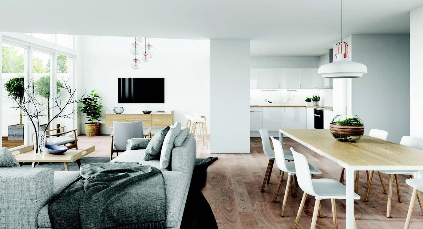 A living room with a couch , table , chairs and a television from one of the Ilios Living accommodation buildings.