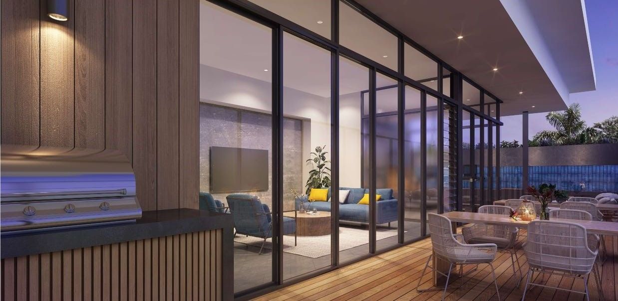 An artist 's impression of a patio with tables and chairs and a grill at Ilios Living in Como.