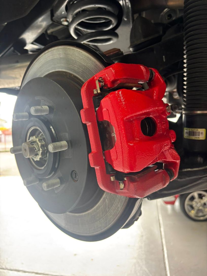 Red Painted Brake Caliper on A Car — Level Up Automotive In Unanderra, NSW