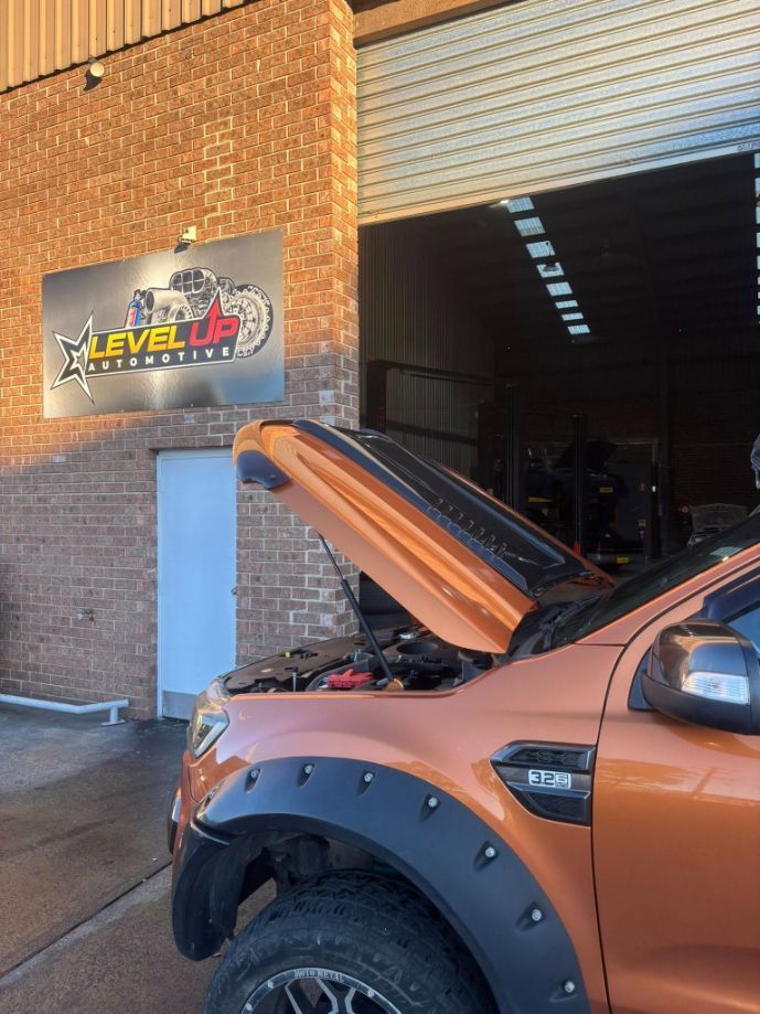 Orange Ford Pickup with Open Hood Outside — Level Up Automotive In Wollongong, NSW