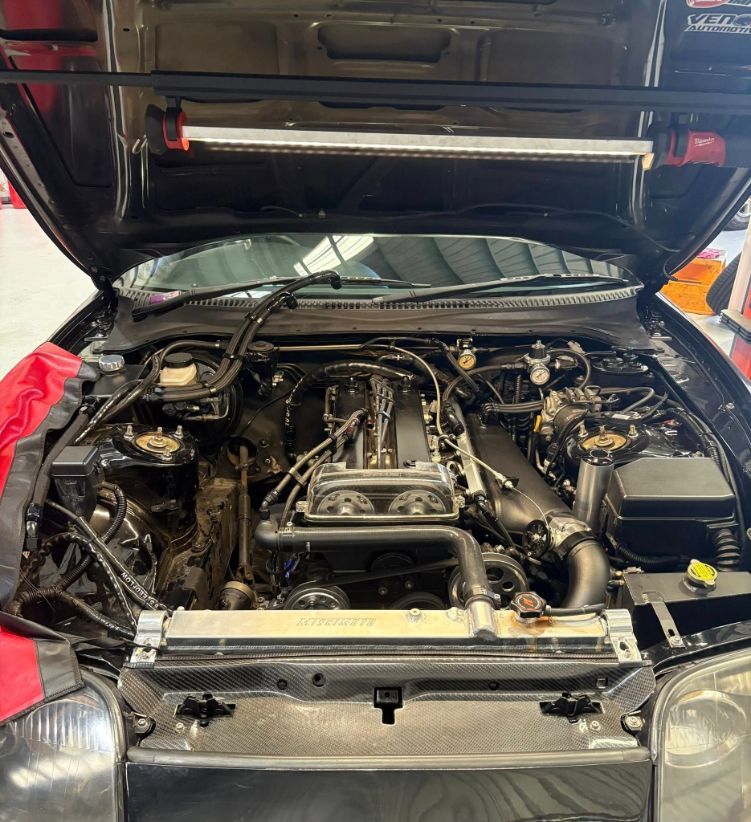 Black Car Engine Bay Open with A Light Above — Level Up Automotive In Unanderra, NSW