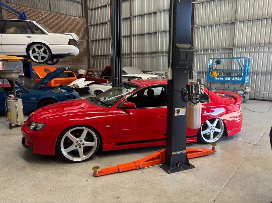 Red Sports Car in A Garage — Level Up Automotive In Wollongong, NSW