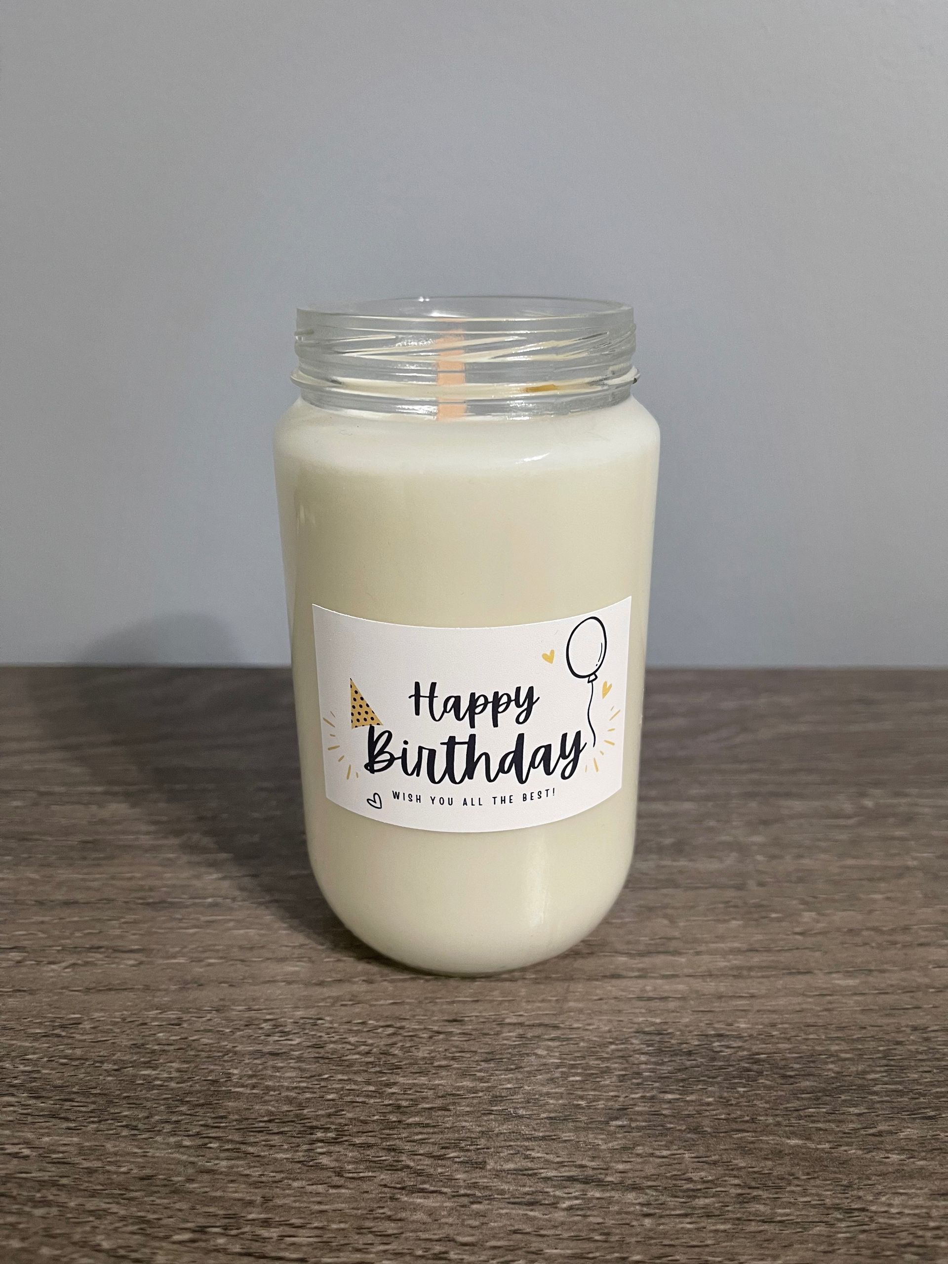 A birthday candle in a clear jar, with 