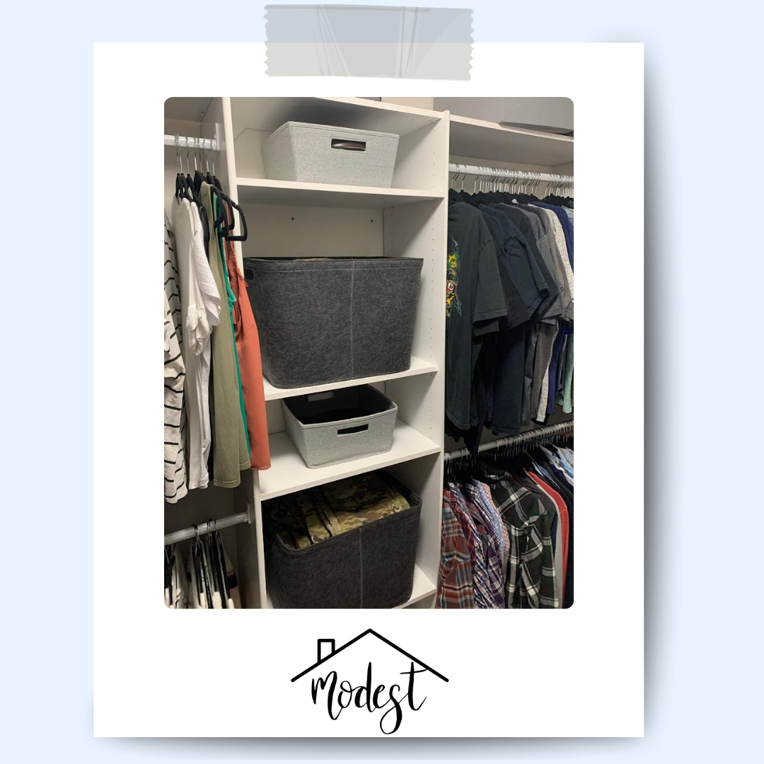 White closet shelves with organized clothes and storage baskets.