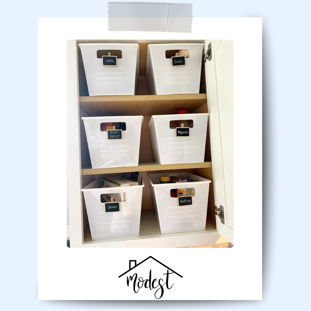 White cabinet with six labeled bins for storage.