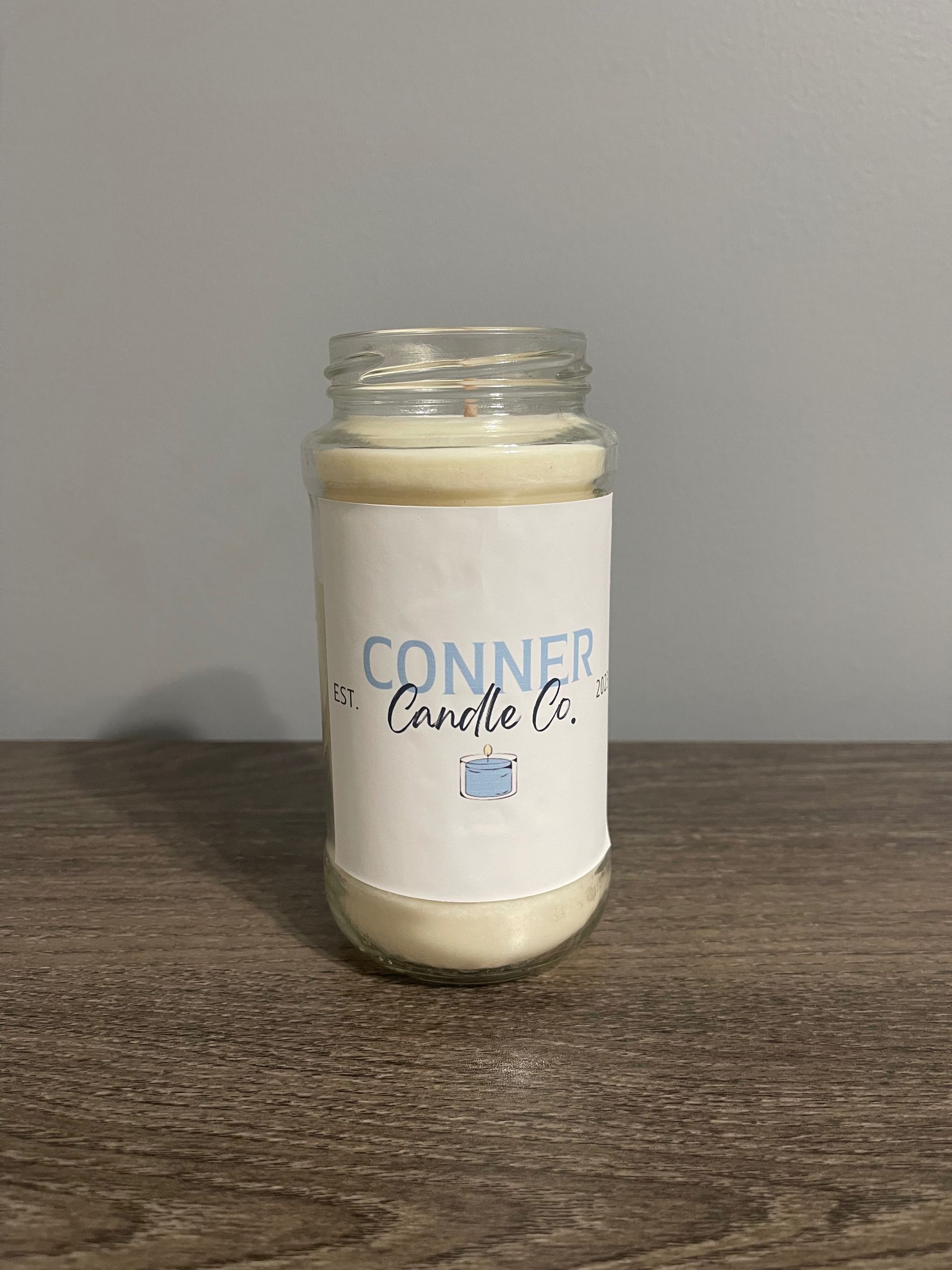 Candle in a jar with a label that says 