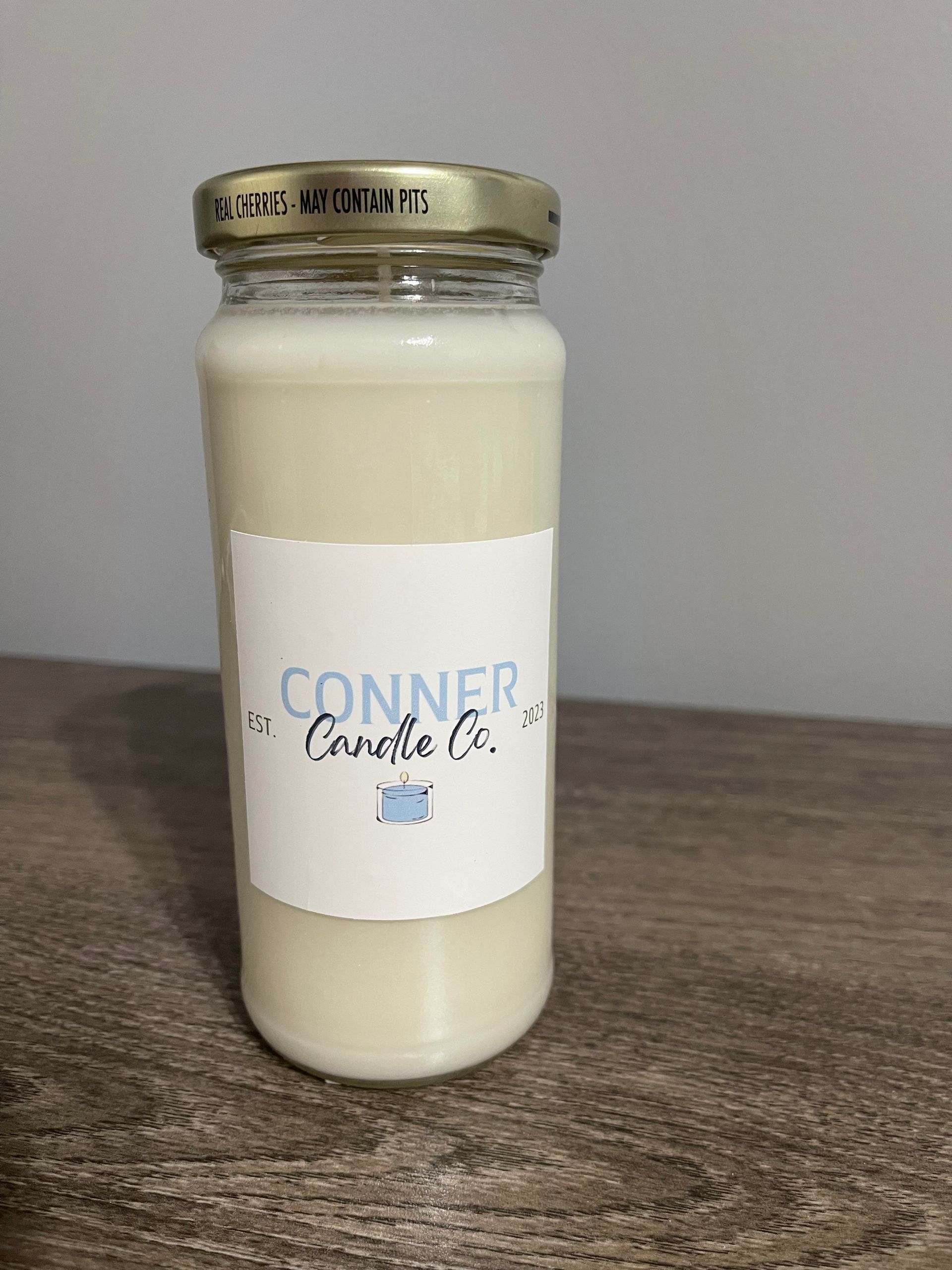 Candle in a jar with label 