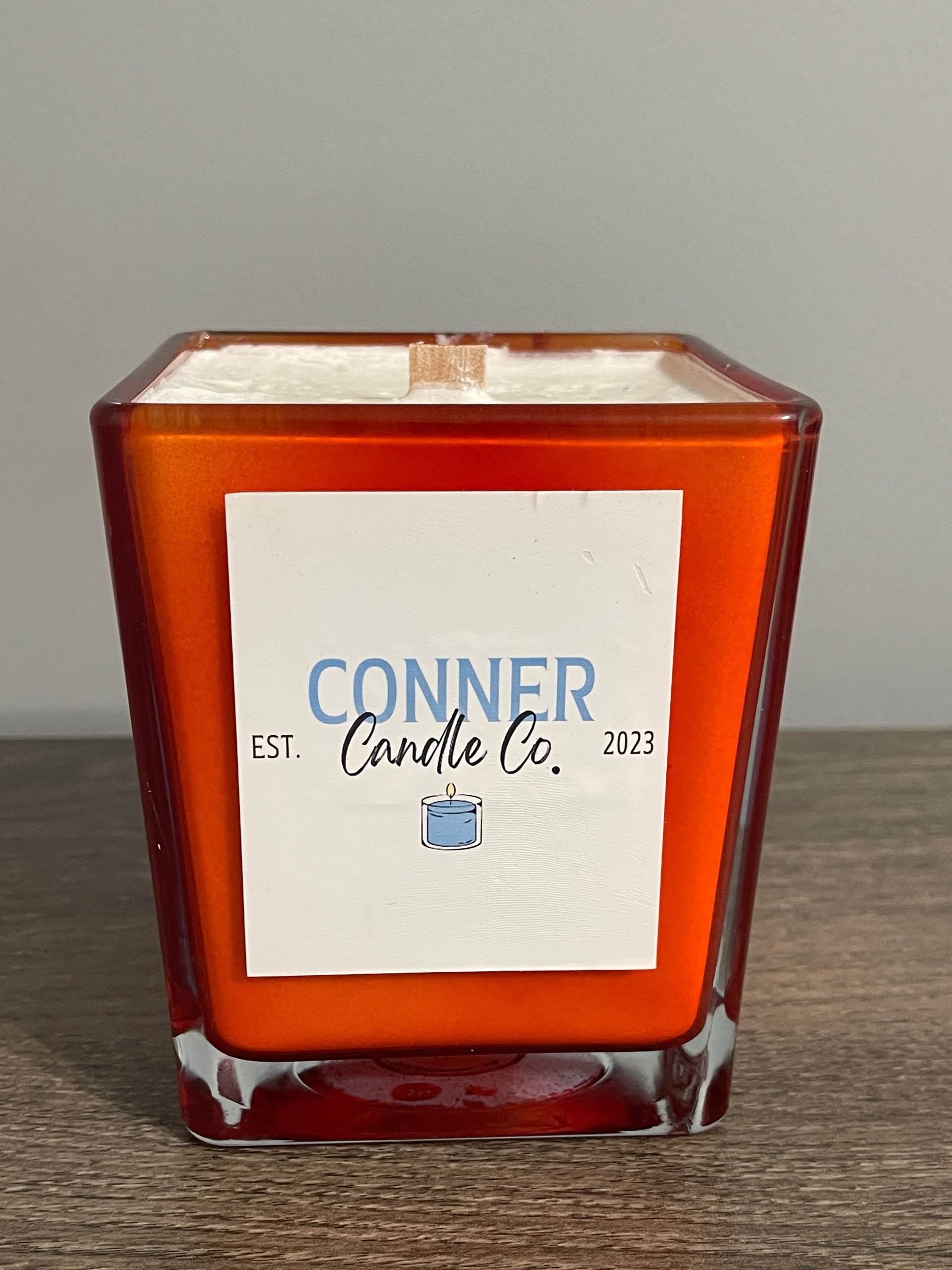 Orange square candle with white label: 