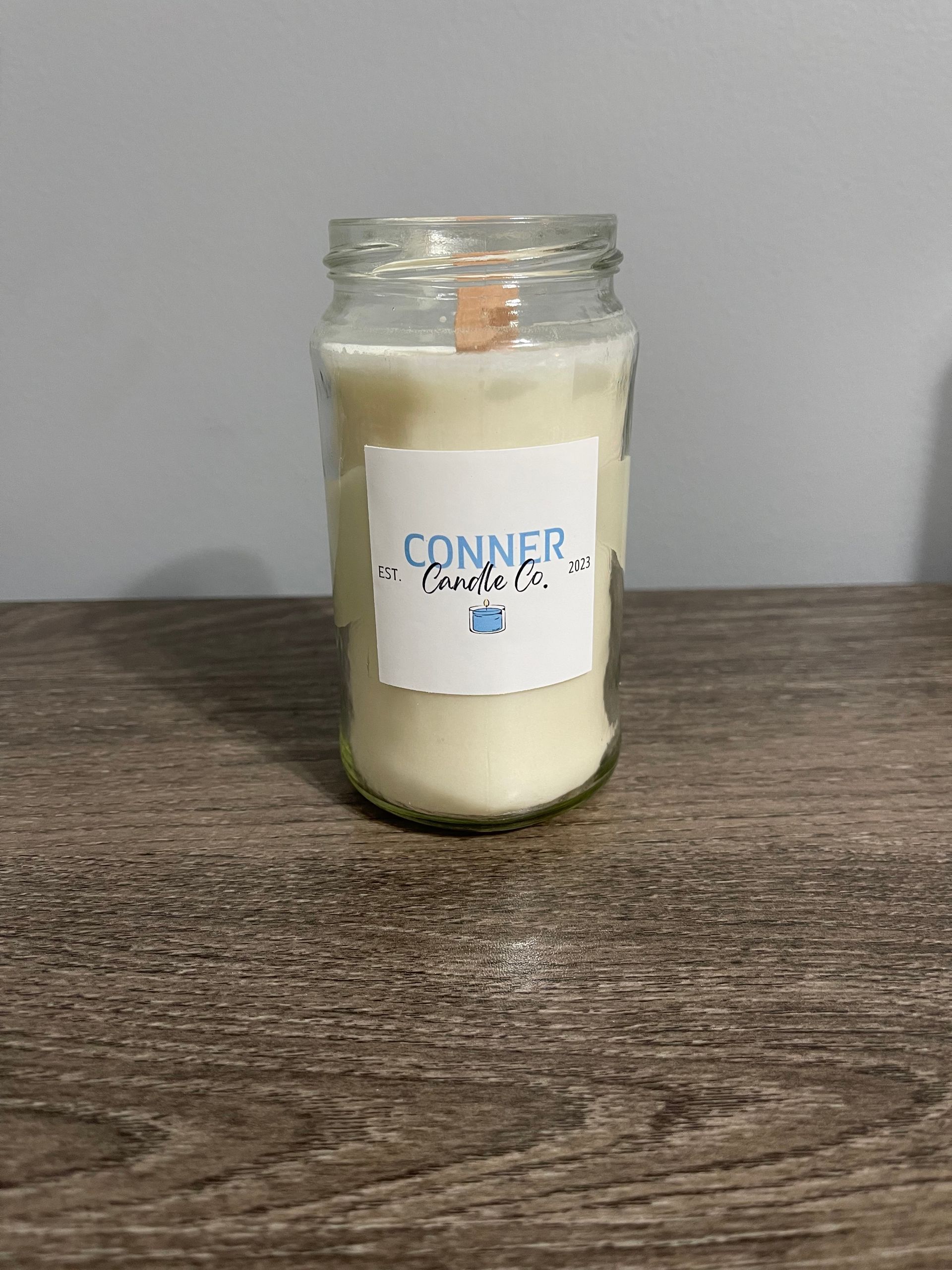 Glass jar candle with wooden wick and label 