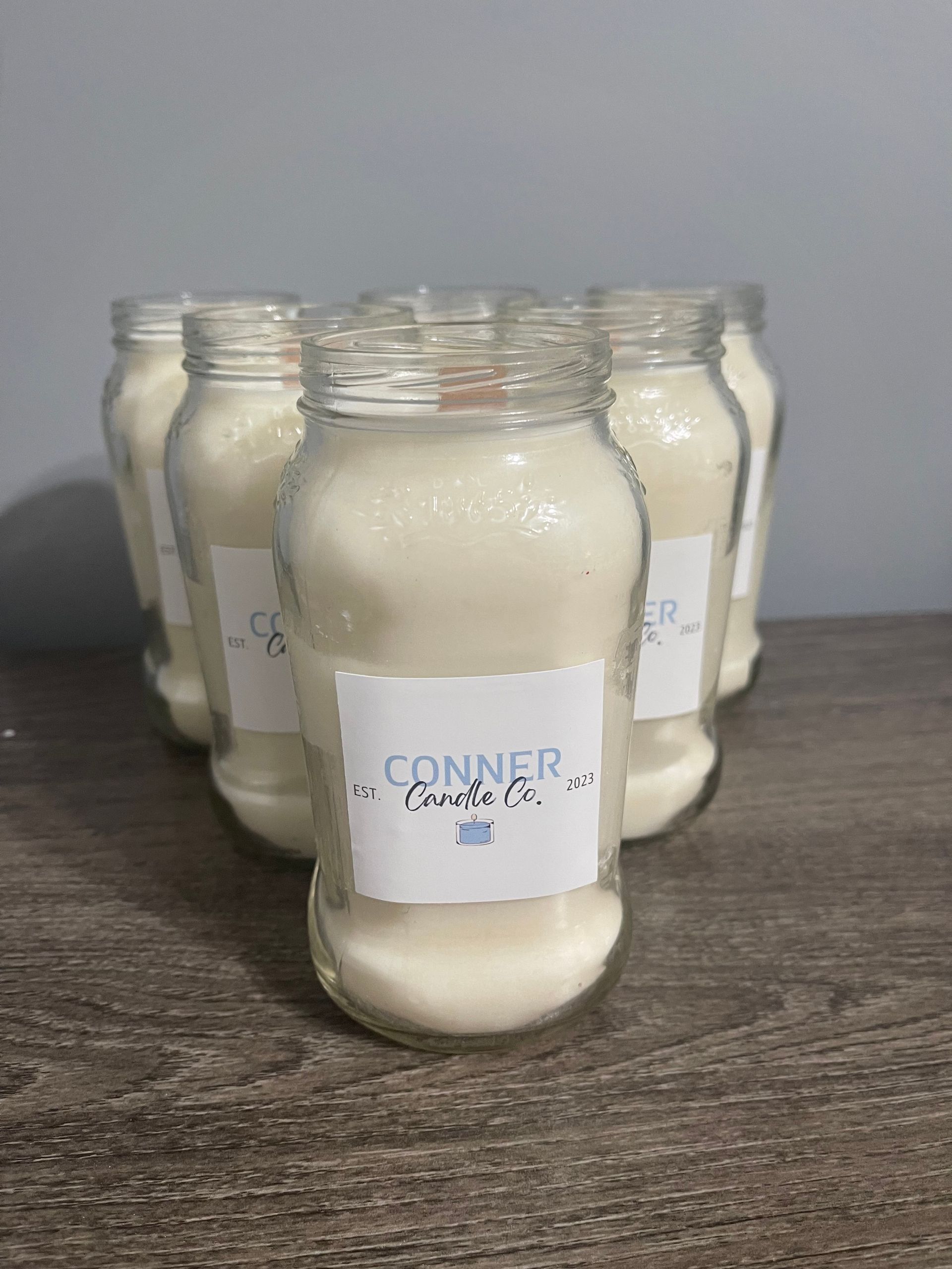 A jar filled with white powder on a wooden surface with a label that says 