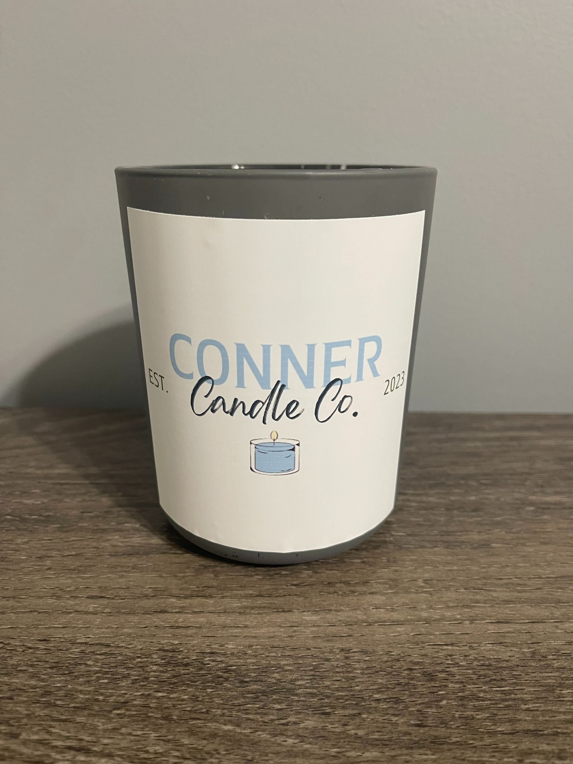 Gray and white candle in a jar with 