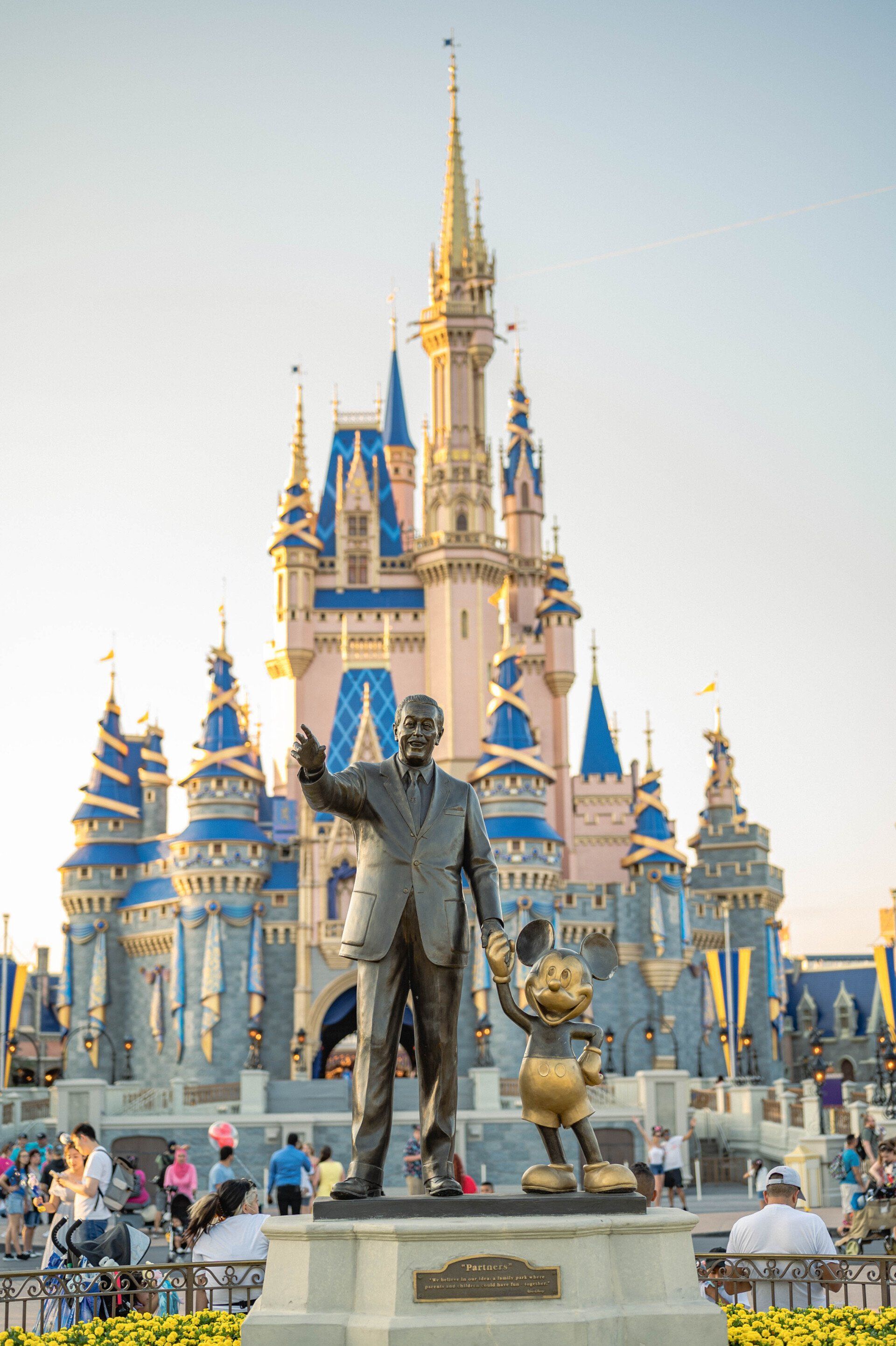 Walt Disney and Mickey Mouse statue in front of Cinderella Castle at Magic Kingdom.