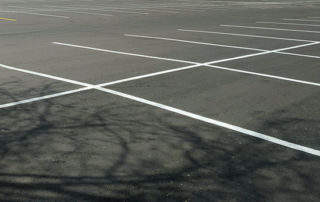 An empty parking lot with white lines on it