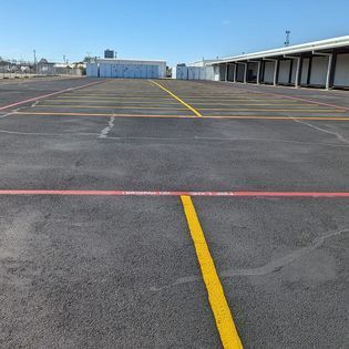 A parking lot with a yellow line in the middle of it.