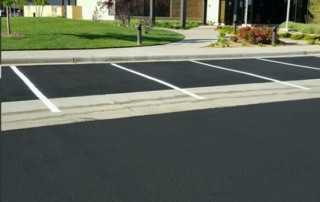 A parking lot with a building in the background