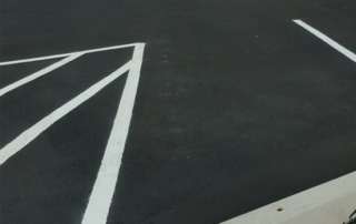 A close up of a parking lot with white lines on it
