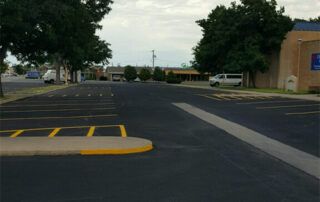 A parking lot with a building in the background