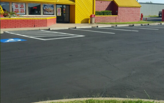 A parking lot in front of a fast food restaurant