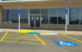 A handicapped parking spot in front of a store