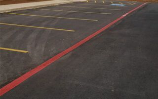 A parking lot with a red line on the side of it.