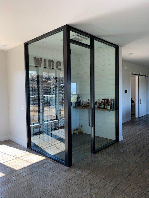 A room with a glass door that says wine on it.