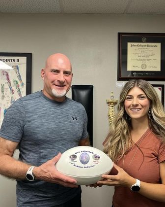 A man and a woman are holding a ball in their hands.